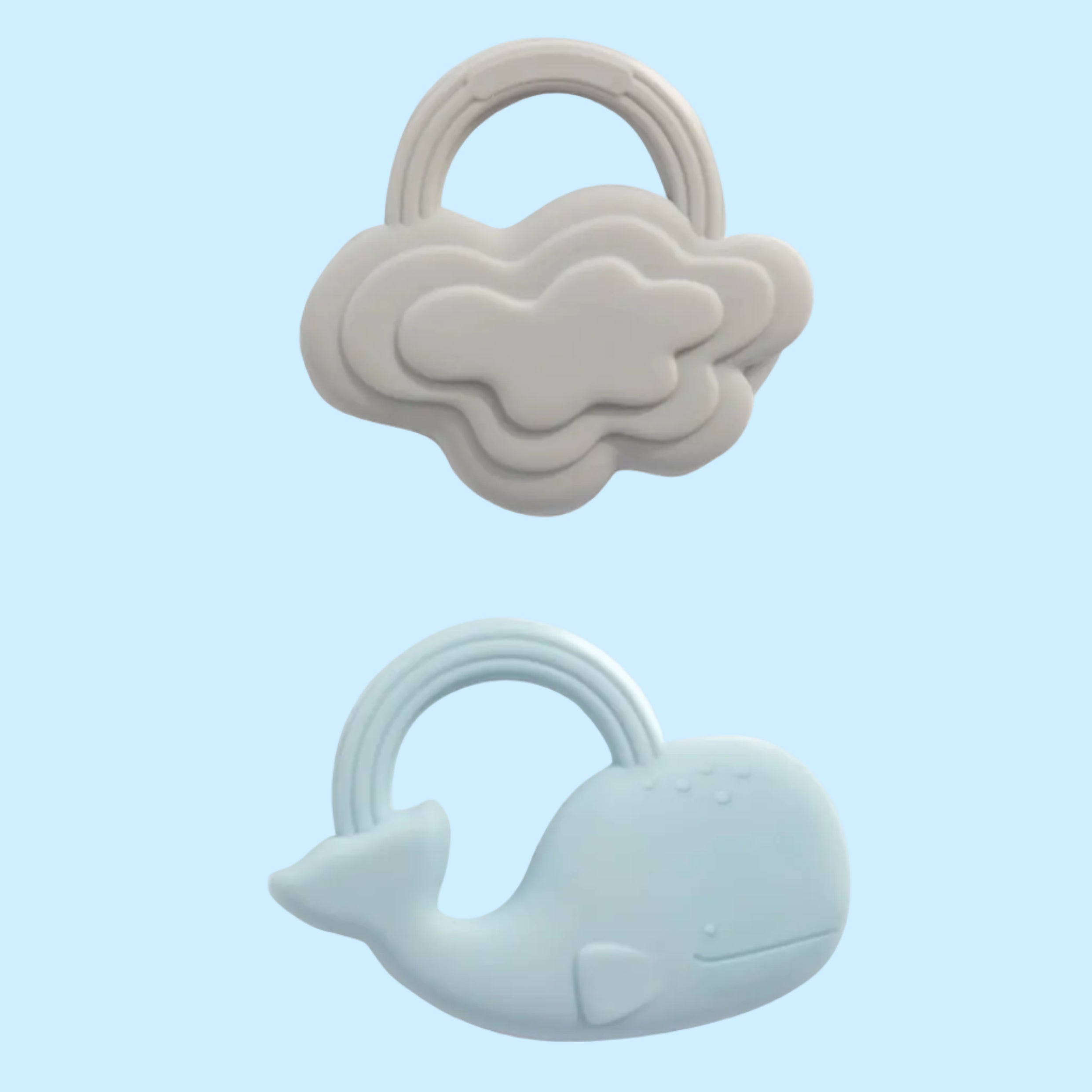 Two baby teething toys, one shaped like a cloud and the other like a whale, on a white background.