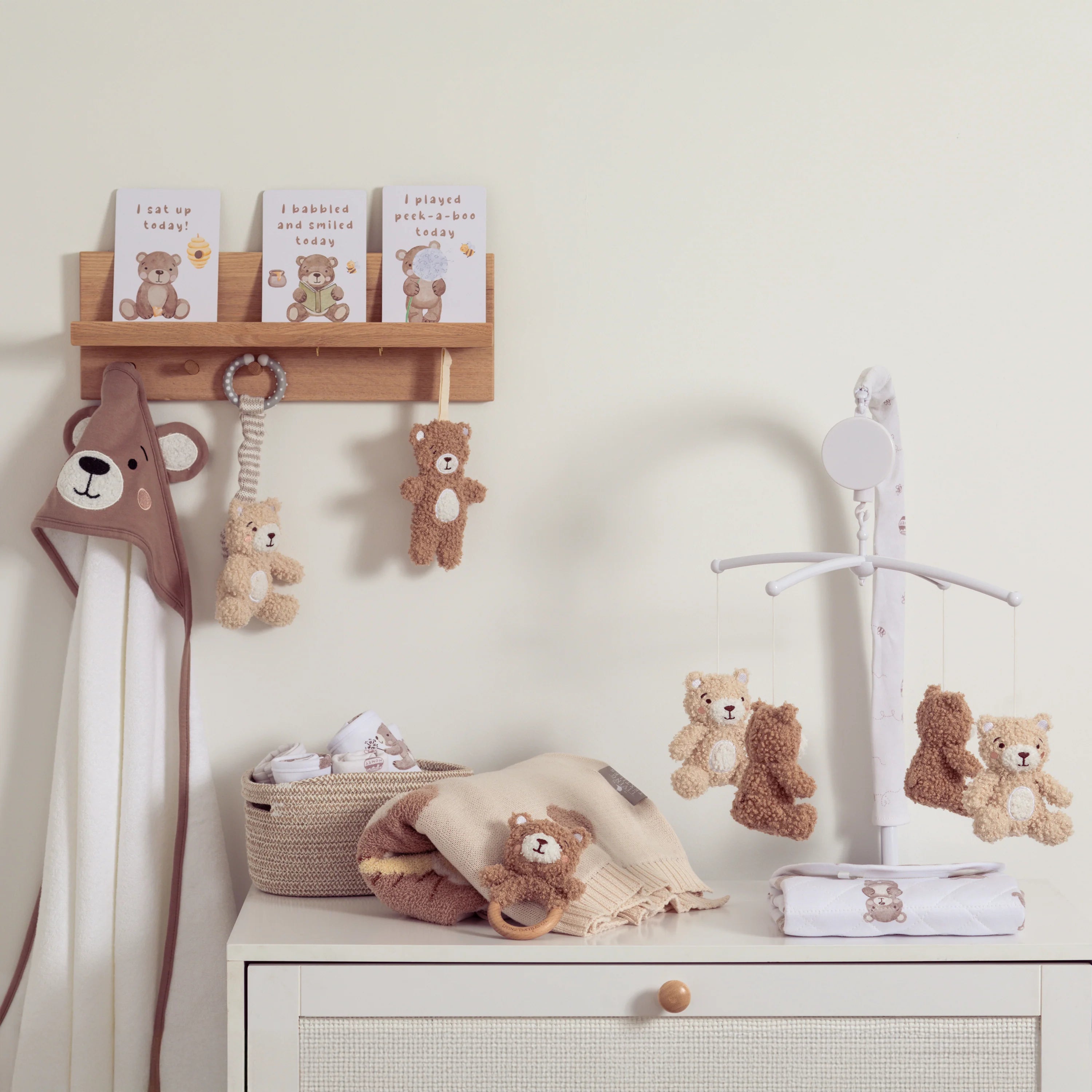 Nursery room with teddy bear-themed decor, including toys and a mobile.