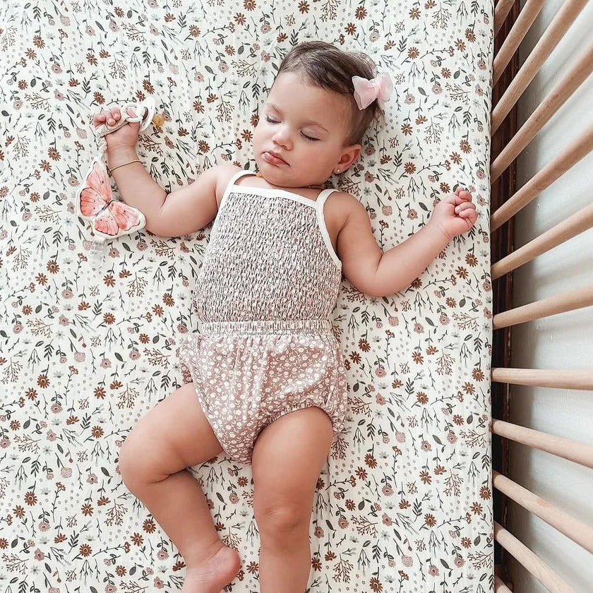 baby holding butterfly sensory toy clip