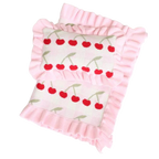 Pink baby blanket with cherry pattern on a white background