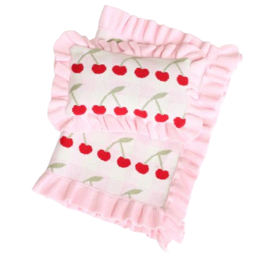 Pink baby blanket with cherry pattern on a white background