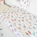 Fairy Garden organic change pad cover stretched over a baby change mat showing soft breathable cotton fabric and floral fairy print