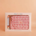 packaging of baby doll nurturer kit that is a nappy bag for kids and comes with a milk bottle and doll food for pretend play and great for gifting the print is pink gingham