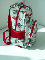 side view of Mini & Mum kids backpack with insulated interior for daycare and outings. can be personalised with childs name. this print is aviator wonders - blue sky with clouds and planes