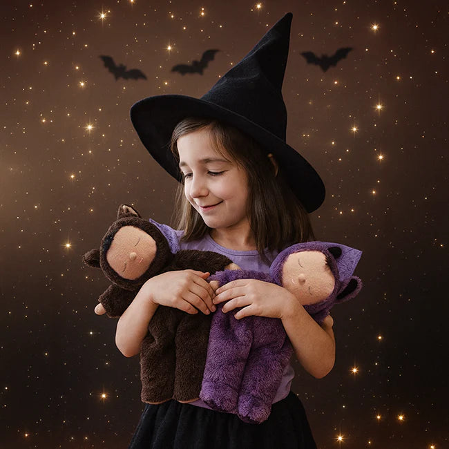 Child holding Ozzie bat Cozy Dinkum plush doll