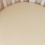 Close up of Lemon Sorbet organic cotton jersey fitted cot sheet showing soft breathable fabric and smooth stretch texture