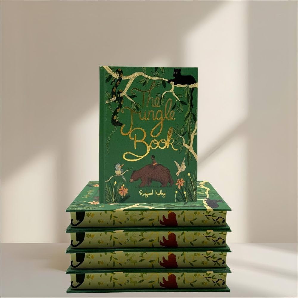 sprayed edges limited edition The Jungle Book collector’s edition hardcover by Rudyard Kipling with green illustrated cover, gold foil title, cloth-bound finish and decorative sprayed edges, stacked on books.