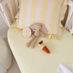 Lemon Sorbet fitted cot sheet by Snuggle Hunny laid flat with nursery accessories, soft stretch organic cotton baby bedding