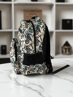 side view of Mini & Mum kids backpack with insulated interior for daycare and outings. can be personalised with childs name. this print is motorbike mania with motorbikes and wrenches, helmets, lighting bolts and smiley faces