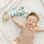 Baby holding Winnie Parkes Diplo the Dino Dragon teether