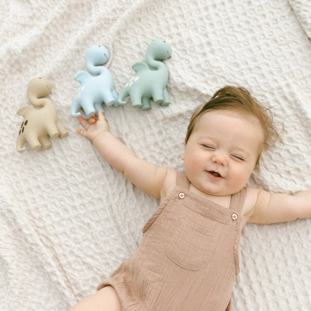 Baby holding Winnie Parkes Diplo the Dino Dragon teether