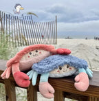 blue and red shaggy crabs on the beach plushy by brand mon ami. embroidered eyes and 3d details, colourblock crab