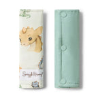 Snuggle Hunny Dragon pram strap covers folded showing soft organic cotton fabric with whimsical dragon print