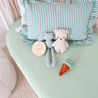 Mint organic fitted cot sheet by Snuggle Hunny laid flat with nursery accessories, soft stretch cotton jersey baby bedding