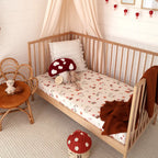 Gnomes print fitted cot sheet by Snuggle Hunny on a baby cot in a cosy nursery setting showing the soft organic cotton fabric