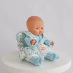 photoshoot of baby dolls carrier made by tiny harlow with baby inside. good for pretend play, the print is blue ducky