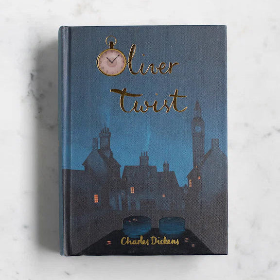  Oliver Twist collector’s edition hardcover by Charles Dickens with navy blue illustrated cover, gold foil title, cloth-bound finish.