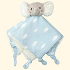 Plush elephant toy with a blue and white polka dot blanket on a white background