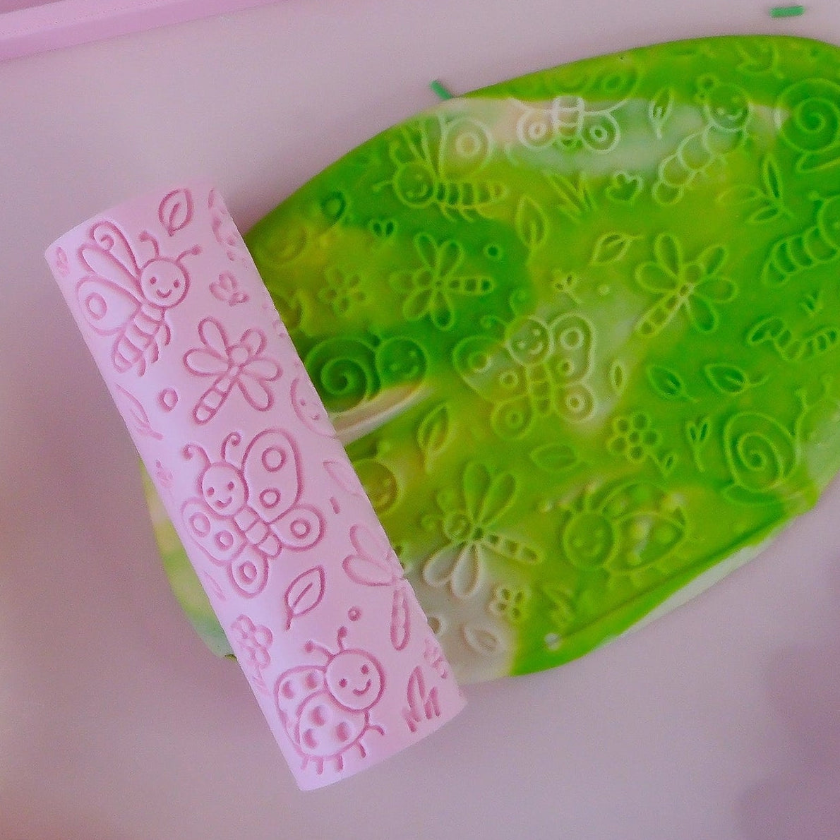 finished product Image of eco textured dough roller designed with fun patterns and to be used with sensory like playdough or can be used for cooking dough. Textured roller is in the pattern bug life
