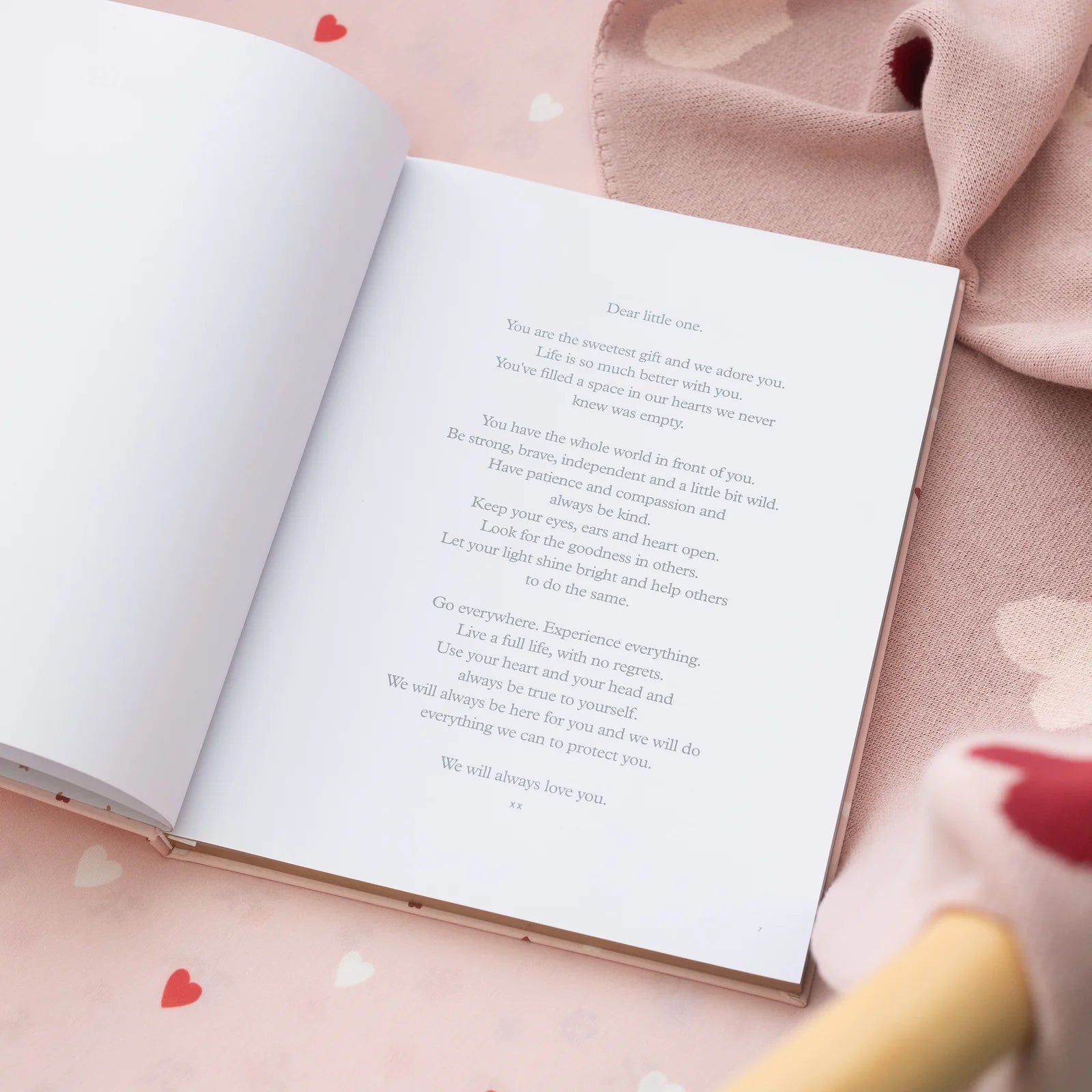 Pink baby memory book with heart pattern for recording milestones
