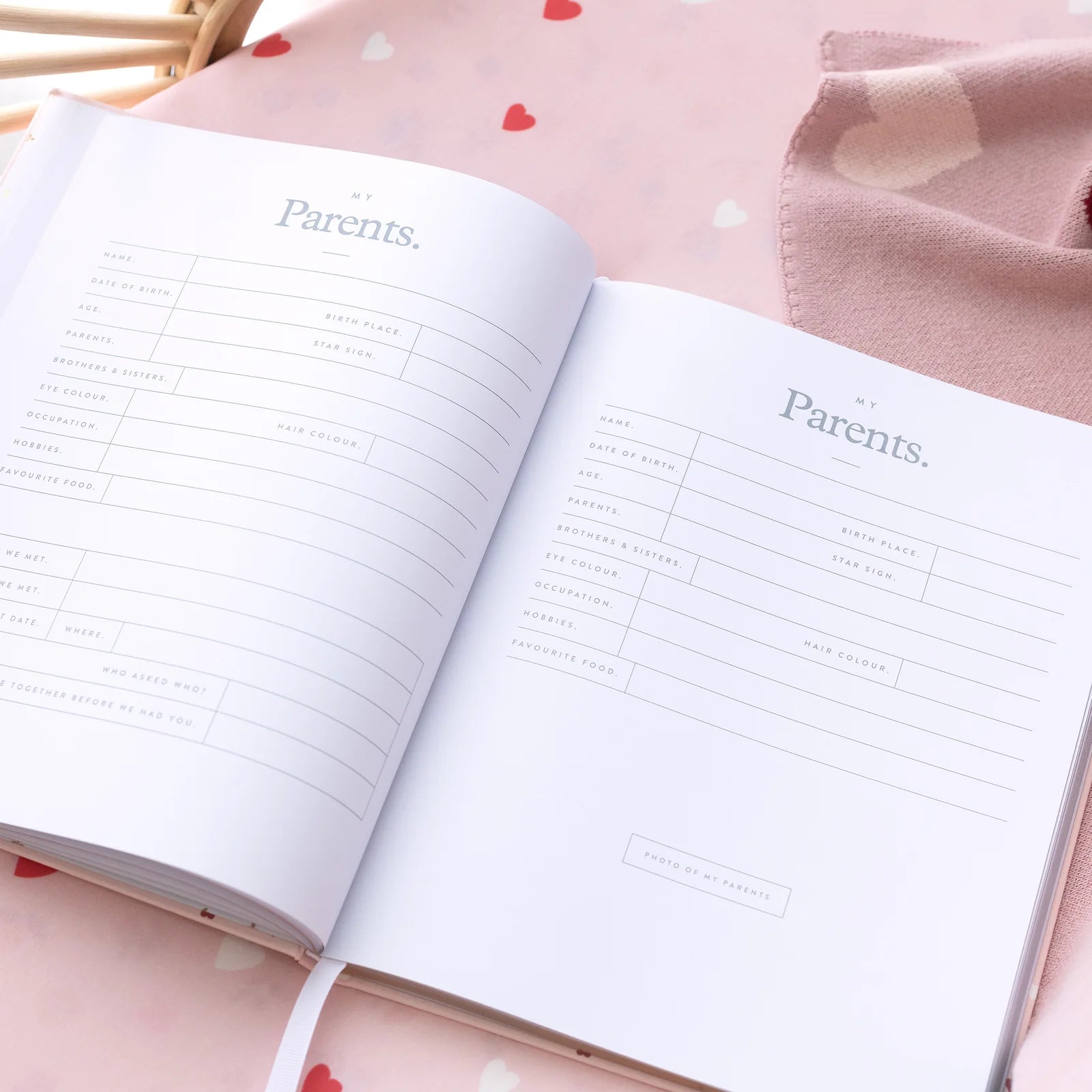 Open notebook with 'My Parents' section on a pink fabric background