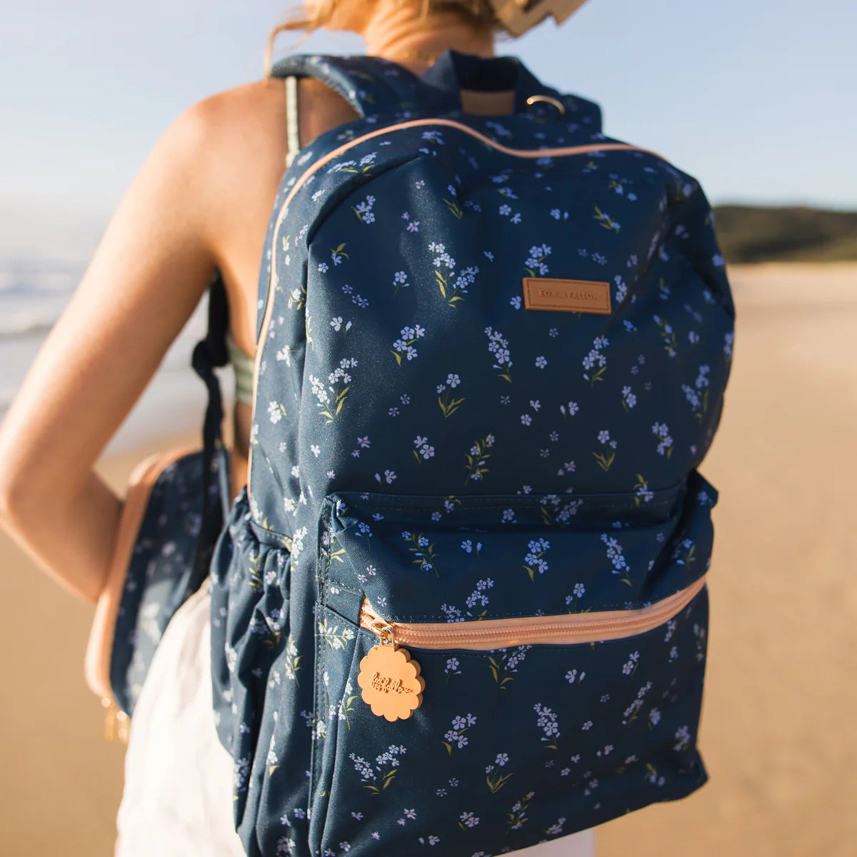 close up wearing Fox & Fallow backpack for kids, perfect for school, daycare and everyday use. Spacious, practical and designed for little adventures. Personalisation of embroidery with name also available on bags in 2 placements. This print is forget me not