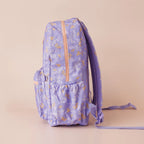 side view of pockets on Fox & Fallow backpack for kids, perfect for school, daycare and everyday use. Spacious, practical and designed for little adventures. Personalisation of embroidery with name also available on bags in 2 placements. This print is juniper - lilac purple with leaves