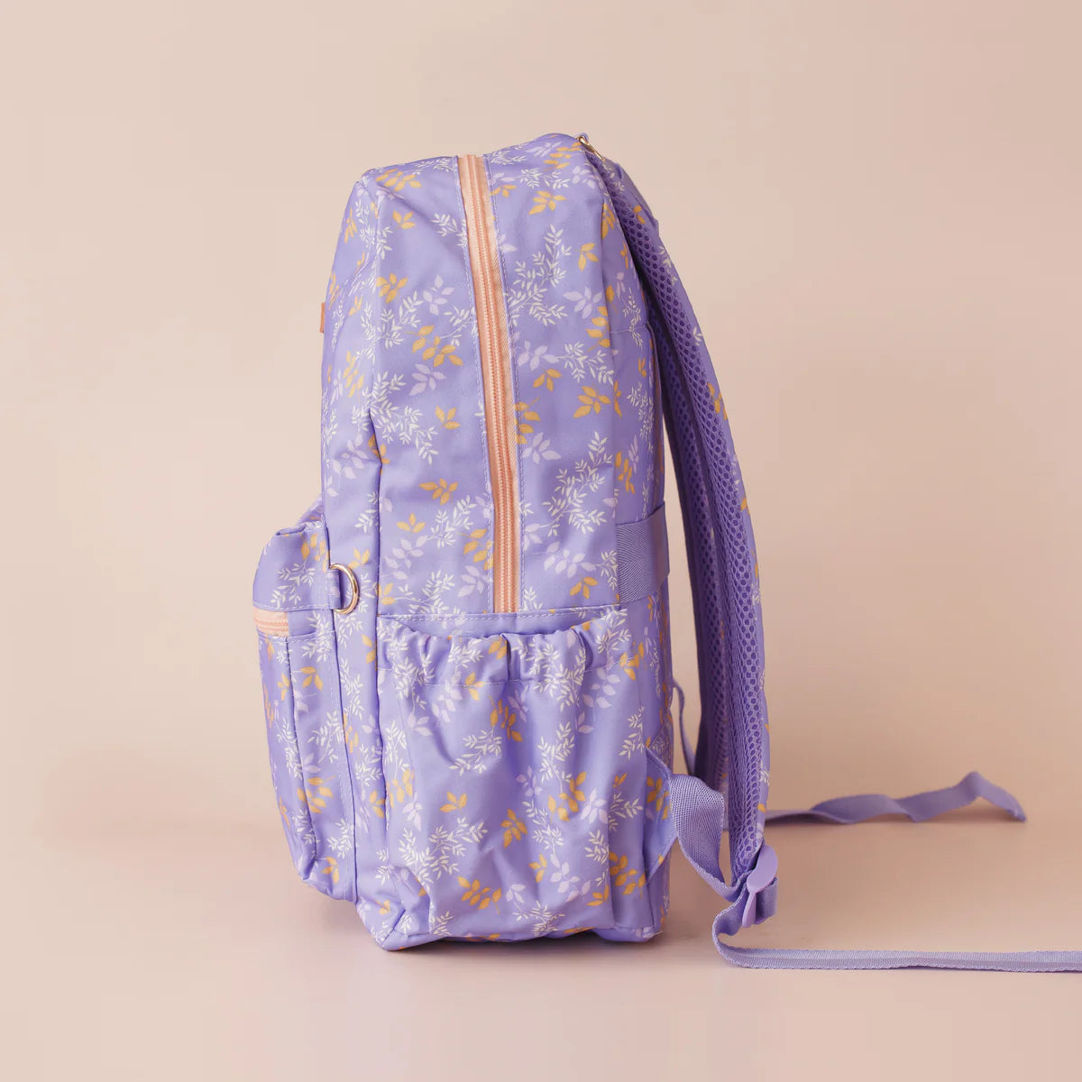 side view of pockets on Fox & Fallow backpack for kids, perfect for school, daycare and everyday use. Spacious, practical and designed for little adventures. Personalisation of embroidery with name also available on bags in 2 placements. This print is juniper - lilac purple with leaves