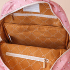 inside view of modelling the Fox & Fallow backpack for kids, perfect for school, daycare and everyday use. Spacious, practical and designed for little adventures. Personalisation of embroidery with name also available on bags in 2 placements. This print is dusty roses