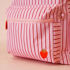 front pocket close up of Fox & Fallow backpack for kids, perfect for school, daycare and everyday use. Spacious, practical and designed for little adventures. Personalisation of embroidery with name also available on bags in 2 placements. This print is strawberry stripe