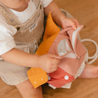 baby playing with Little Lamb Kind busy cube sensory toy neutral colours
