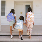 kids walking in home siblings Fox & Fallow sage check backpack front view kids school bag