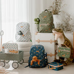 photoshoot with Fox & Fallow backpack for kids, perfect for school, daycare and everyday use. Spacious, practical and designed for little adventures. Personalisation of embroidery with name also available on bags in 2 placements. This print is dinos, trucks and sage check
