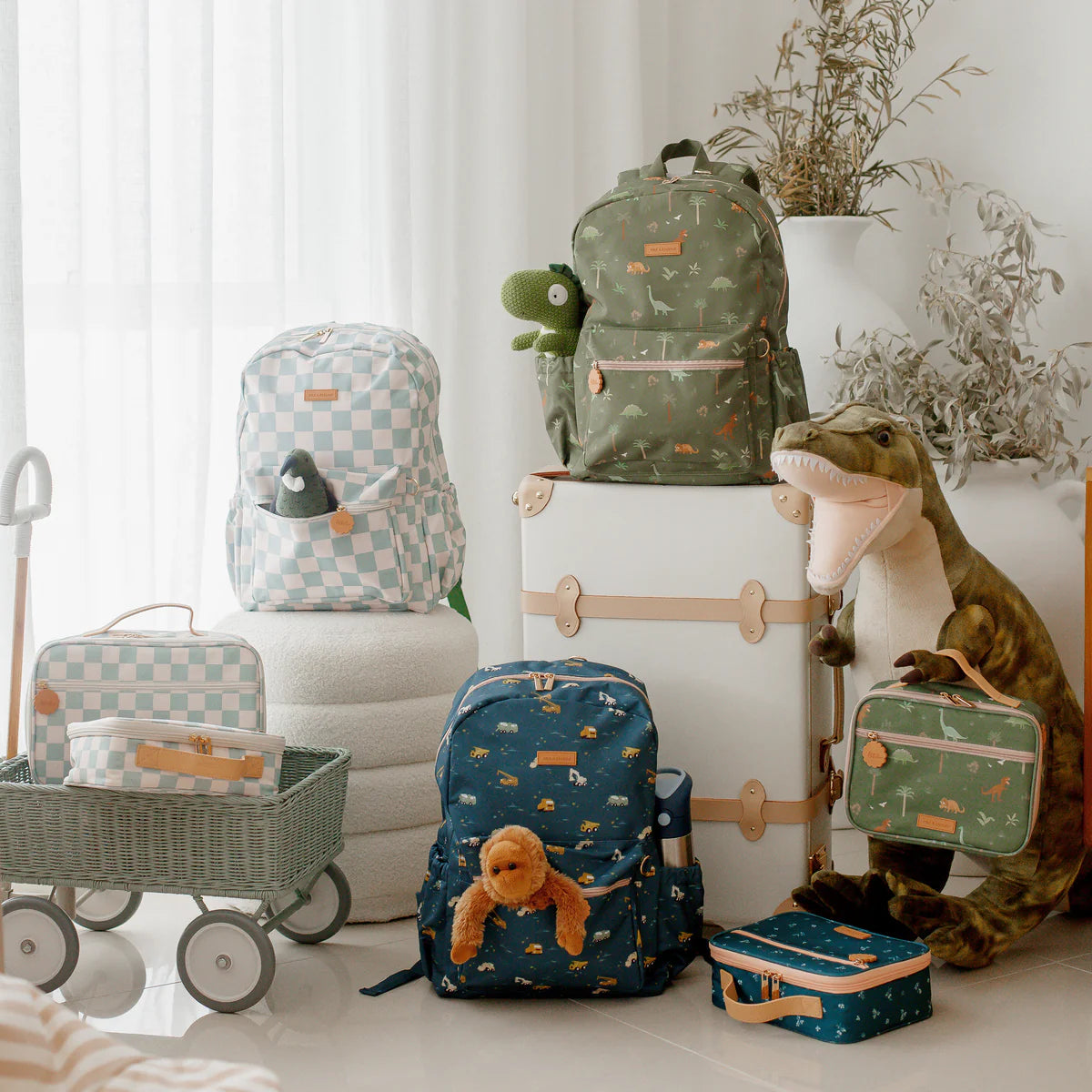 photoshoot with Fox & Fallow backpack for kids, perfect for school, daycare and everyday use. Spacious, practical and designed for little adventures. Personalisation of embroidery with name also available on bags in 2 placements. This print is dinos, trucks and sage check