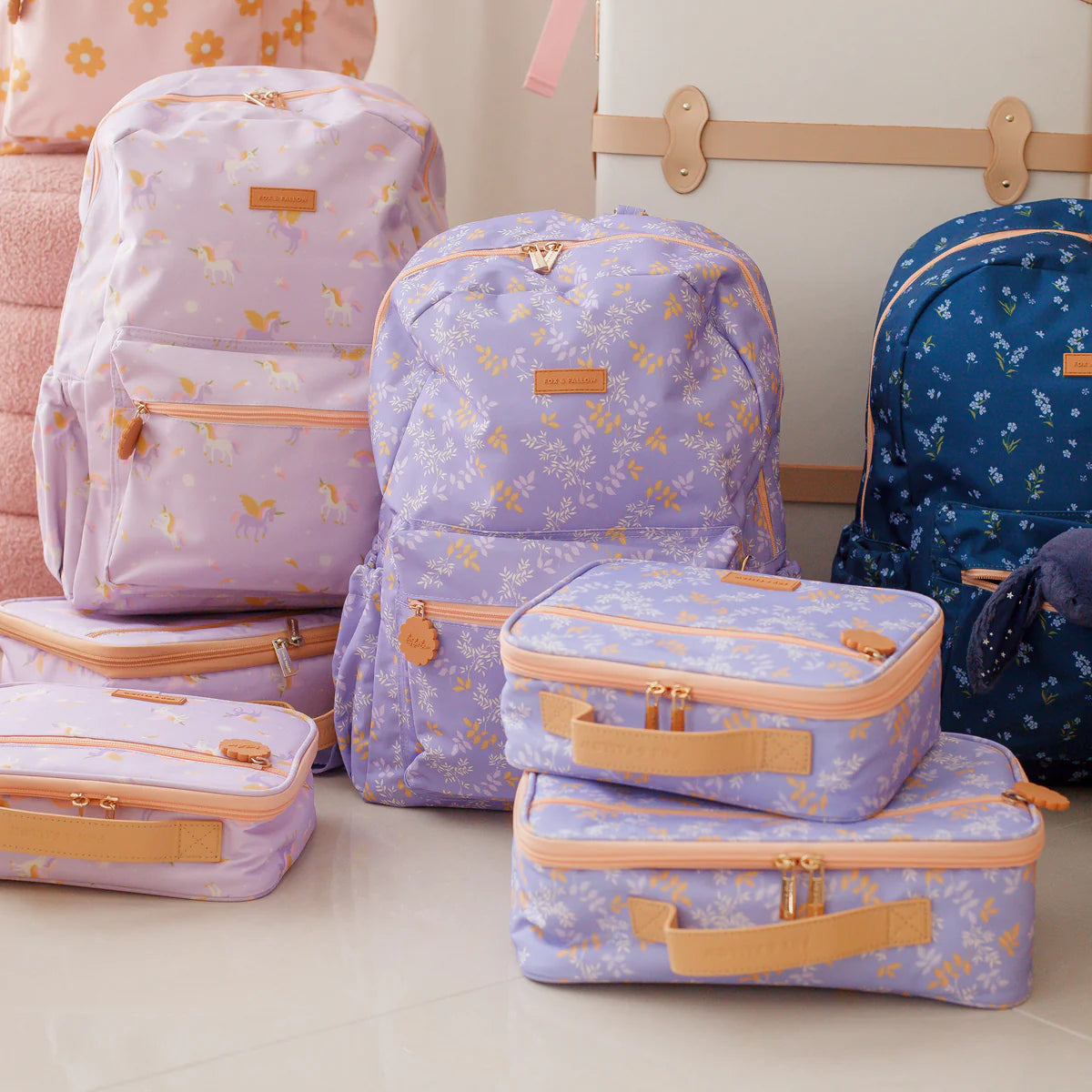 photoshoot of Fox & Fallow backpack for kids, perfect for school, daycare and everyday use. Spacious, practical and designed for little adventures. Personalisation of embroidery with name also available on bags in 2 placements. This print is juniper - lilac purple with leaves, unicorns and forget me not