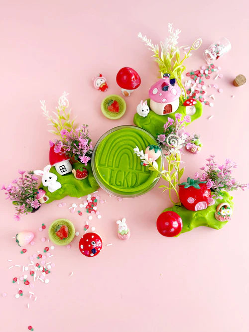 Strawberry themed sensory dough with bunny charms, mushroom house, foliage and berry sprinkles for imaginative small world play