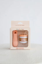 Product packaging with a jar and spoon on a light background