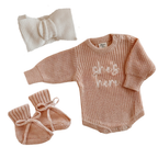 Blossom and Pear baby girl announcement outfit with pink She’s Here knit romper set