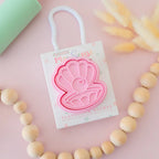 photoshoot of image of playdough/clay stamp and cutter. Eco-friendly sensory play tool by brand playsense perfect for creative and imaginative play. can also be used for cookies and baking. pictured is pearl shell