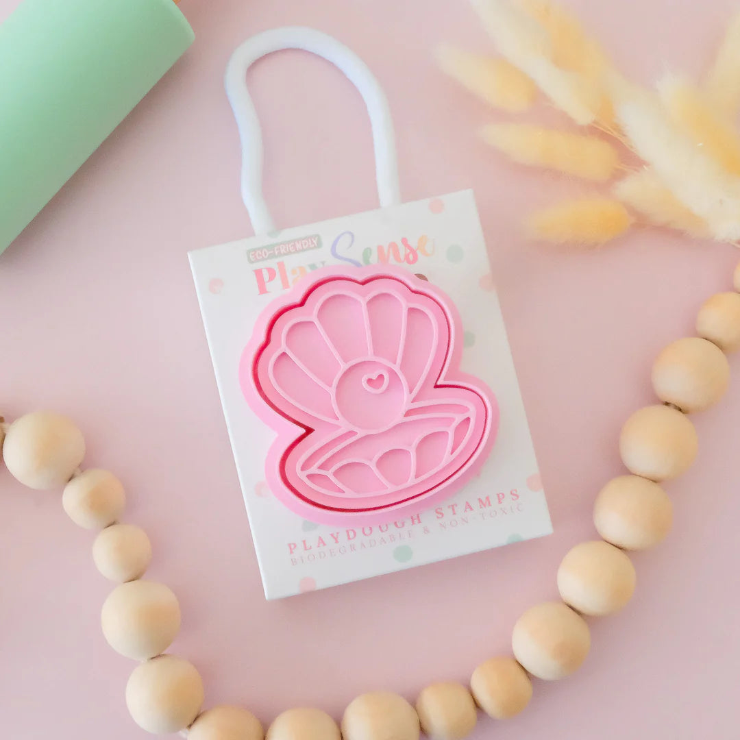 photoshoot of image of playdough/clay stamp and cutter. Eco-friendly sensory play tool by brand playsense perfect for creative and imaginative play. can also be used for cookies and baking. pictured is pearl shell