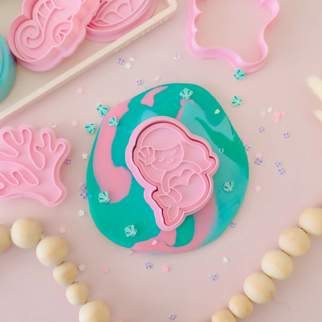 showing how to use image of playdough/clay stamp and cutter. Eco-friendly sensory play tool by brand playsense perfect for creative and imaginative play. can also be used for cookies and baking. pictured is mermaid