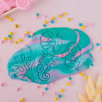 showing how to use set image of playdough/clay stamp and cutter. Eco-friendly sensory play tool by brand playsense perfect for creative and imaginative play. can also be used for cookies and baking. pictured is mermaid, pearl shell, coral and seahorse