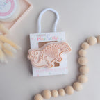 photoshoot image of playdough/clay stamp and cutter. Eco-friendly sensory play tool by brand playsense perfect for creative and imaginative play. can also be used for cookies and baking. pictured is stegosaurus