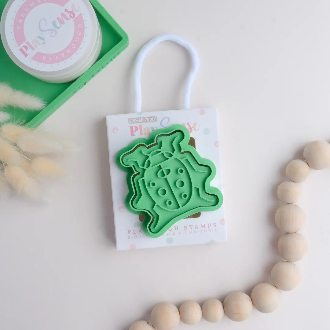 photoshoot of image of playdough/clay stamp and cutter. Eco-friendly sensory play tool by brand playsense perfect for creative and imaginative play. can also be used for cookies and baking. pictured is ladybug
