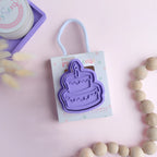 photoshoot image of playdough/clay stamp and cutter. Eco-friendly sensory play tool by brand playsense perfect for creative and imaginative play. can also be used for cookies and baking. pictured is celebration cake