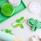 in use showing image of playdough/clay stamp and cutter. Eco-friendly sensory play tool by brand playsense perfect for creative and imaginative play. can also be used for cookies and baking. pictured is dragonfly