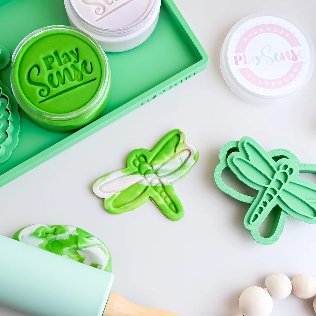 in use showing image of playdough/clay stamp and cutter. Eco-friendly sensory play tool by brand playsense perfect for creative and imaginative play. can also be used for cookies and baking. pictured is dragonfly