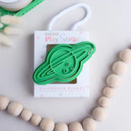 photoshoot image of playdough/clay stamp and cutter. Eco-friendly sensory play tool by brand playsense perfect for creative and imaginative play. can also be used for cookies and baking. pictured is saturn
