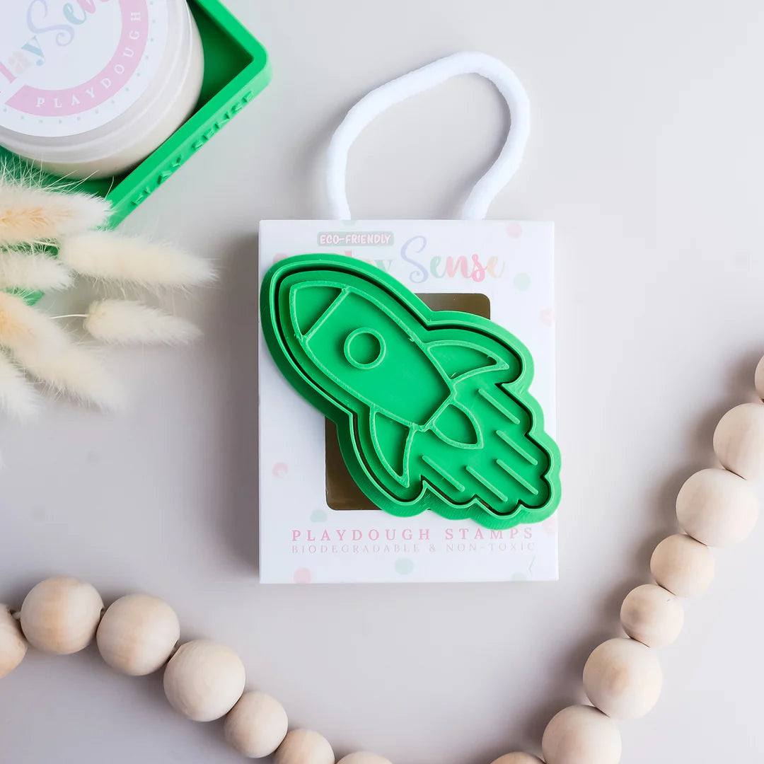 photoshoot image of playdough/clay stamp and cutter. Eco-friendly sensory play tool by brand playsense perfect for creative and imaginative play. can also be used for cookies and baking. pictured is rocket