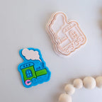 showing how to use image of playdough/clay stamp and cutter. Eco-friendly sensory play tool by brand playsense perfect for creative and imaginative play. can also be used for cookies and baking. pictured is steam train